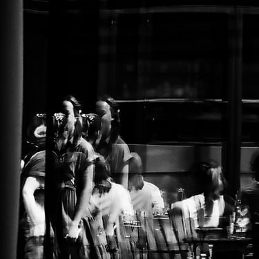 A woman is distorted by the reflection of a window in Quartermile, Edinburgh