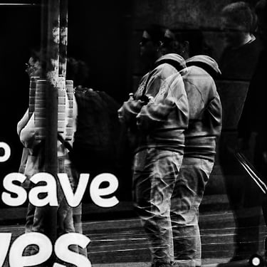 Several people are distorted by the reflection of a window on Leith Street, Edinburgh