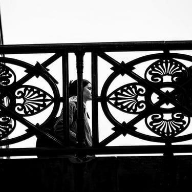 A woman seen through the fence on George IV Bridge, from The Cowgate, Edinburgh