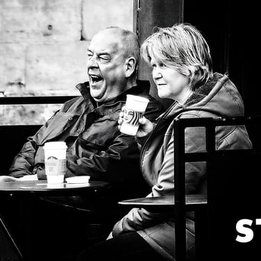 A man yawns as a woman has a coffee at Starbucks on The High Street, Edinburgh