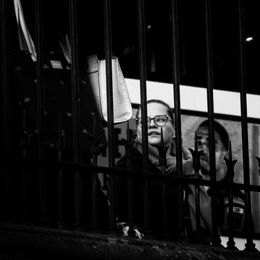 A woman , her face highlighted by the sun, against a shadow background on Princes Street