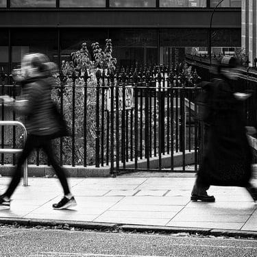Two women, both blurred in motion, on Lauriston Place, Edinburgh