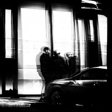 Three men, standing having a chat reflected in glass at Port Hamilton, Edinburgh