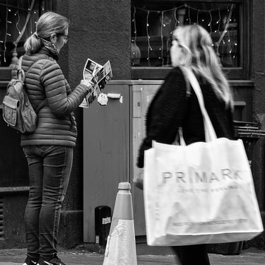 A woman tourist looking at brochure at the corner of Jeffrey Street by The High Street, Edinburgh