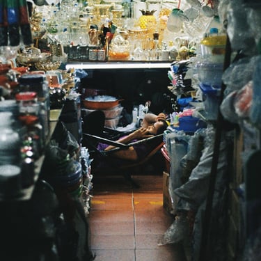 Market vendor relaxing in Saigon