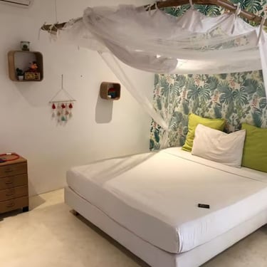 a bed with a canopy bed and a white bed