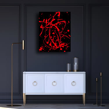 Red and black abstract wall art by O. Seger hanging above a white sideboard in a modern dark room