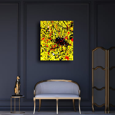 Abstract yellow and black splatter art by Olivia Seger hanging in a luxury dark grey living room.
