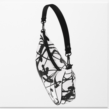 White crescent-shaped shoulder bag by Vymoyre feat. a black abstract line print and leather strap.