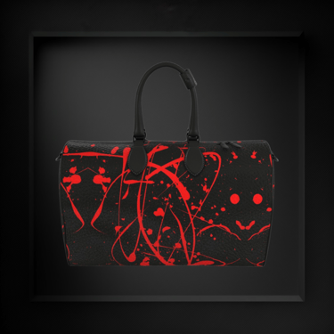 Designer black leather duffle bag by Vymoyre with vibrant red paint splatter art in a luxury display