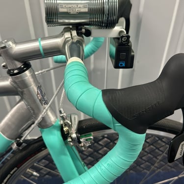 combo mount on a green bike with exposure light and Gopro camera installed