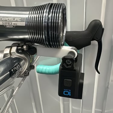 combo mount on a green bike with exposure light and Gopro camera installed