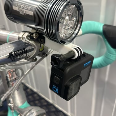 combo mount on a green bike with exposure light and Gopro camera installed