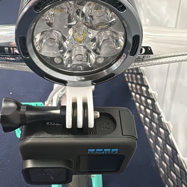 combo mount on a green bike with exposure light and Gopro camera installed