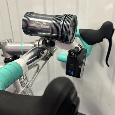 combo mount on a green bike with exposure light and Gopro camera installed