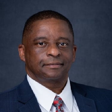 Elder Mark wearing a suit with a red tie