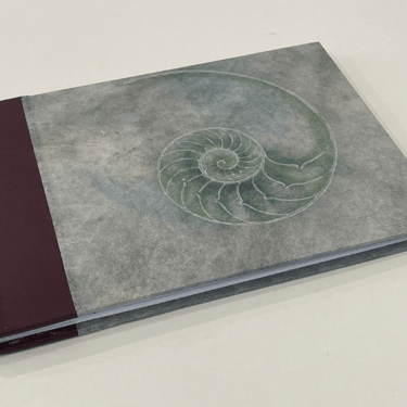 Journal with leather spine and shell design cover