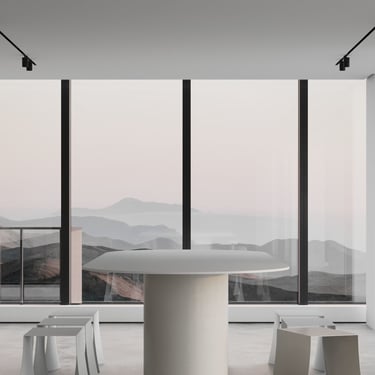 3D rendering of a minimalist space with sculptural stools, round table, soft daylight, and mountain views through tall window