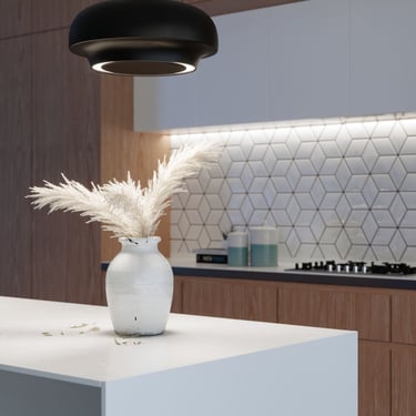 3D rendering of a modern kitchen with black pendant light, white island, pampas grass vase, and hexagonal tile backsplash.