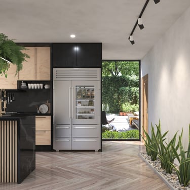 Modern kitchen with stainless steel refrigerator, wood cabinets, herringbone floors, green plants, and outdoor patio access.
