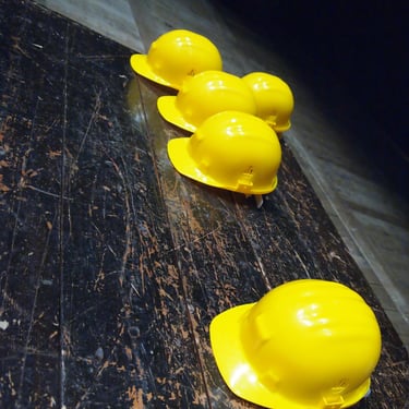 a row of yellow hard hats