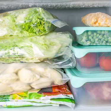 Frozen vegetables and meals stored in freezer containers, showing emergency food storage and long-term preservation