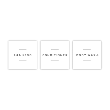 a white bathroom with a white wall and a black and white sign