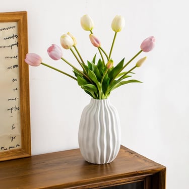 a vase with flowers in a vase on a table