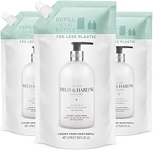 three bottles of bath soap with a bottle of water