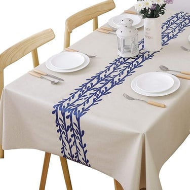 a table with a tablecloth and plates and silverware