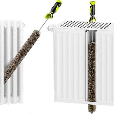 a pair of scissors and a brush brush on a white radiator
