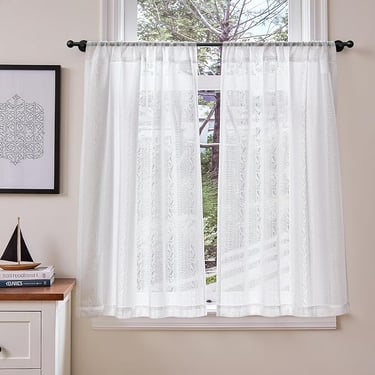 a window curtain with a sailboat on it