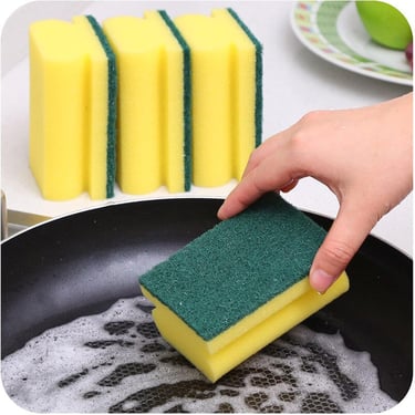 a person cleaning a pan with sponges on a pan