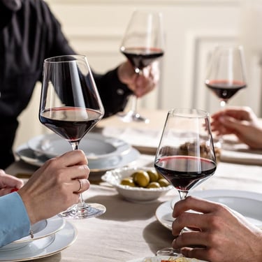a group of people sitting at a table with wine glasses