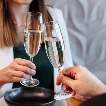 a man and woman holding glasses of champagne