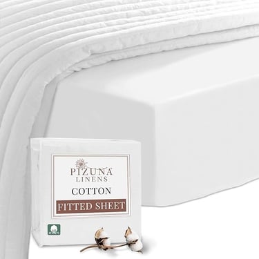 a bed with a white bedding and a pillow