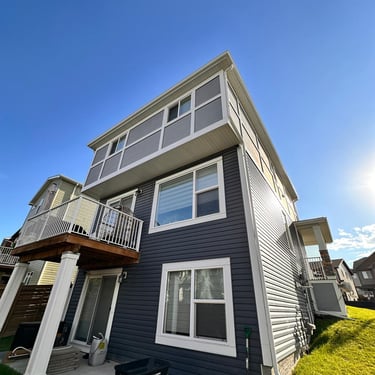 Everdrains technician cleaning a residential gutter to prevent clogs and water damage in Calgary