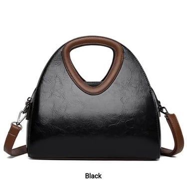 a black and white handbag with a brown leather handbag