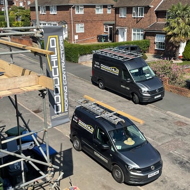 Residential Road showing two Goodchild vans parked next to job with scaffold