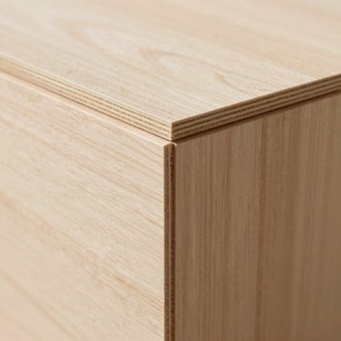 Close-up architectural shot of structured low-formaldehyde timber board edges, showcasing natural light wood grain texture, clean studio daylight