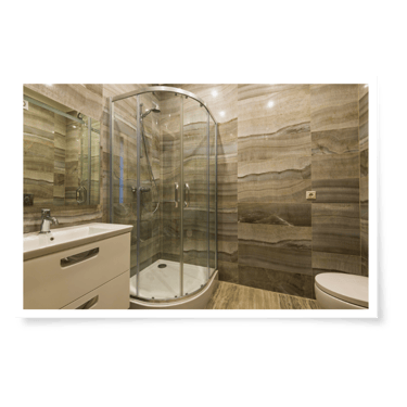 a bathroom with a glass shower and a toilet