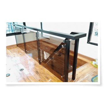 a glass railing with a glass and a wooden floor