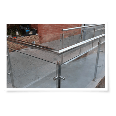 a metal railing railing with a glass