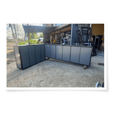a corner of a room with a large aluminum kitchen cabinet