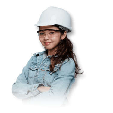 A woman wearing a white hard hat and denim jacket stands confidently with arms crossed against a black background.