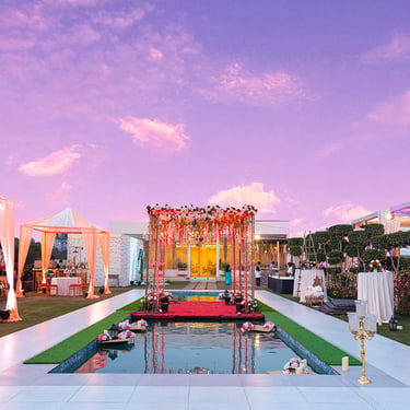 Wedding mandap decor over a poolside venue at dusk