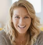 a woman with blonde hair and a gray sweater