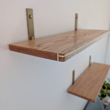 custom oak floating shelves with brass inlay for office