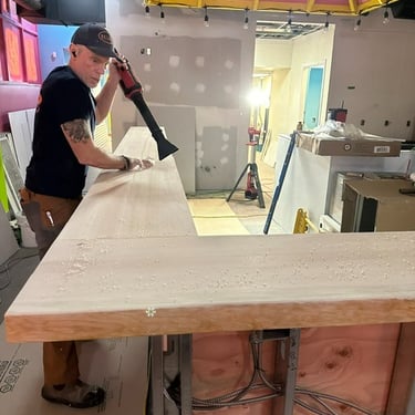 a man is using a sandblaker to make a counter top