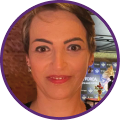 a woman with short hair and a purple shirt
